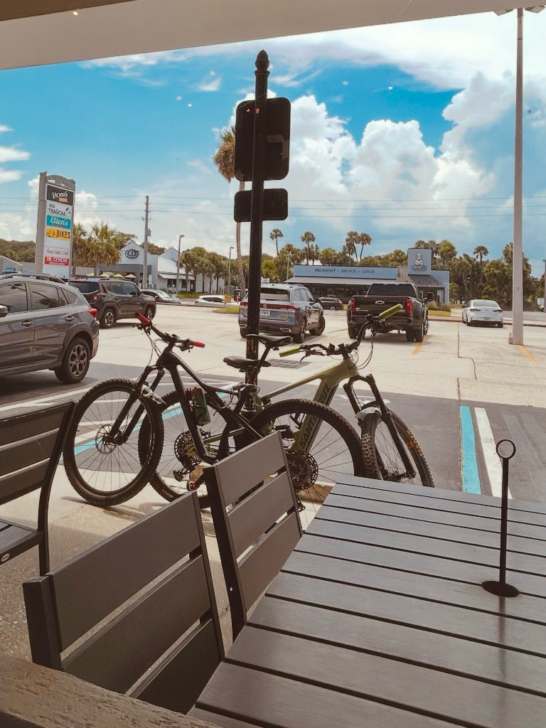 Mountain bikes parked outside a cafe after a ride